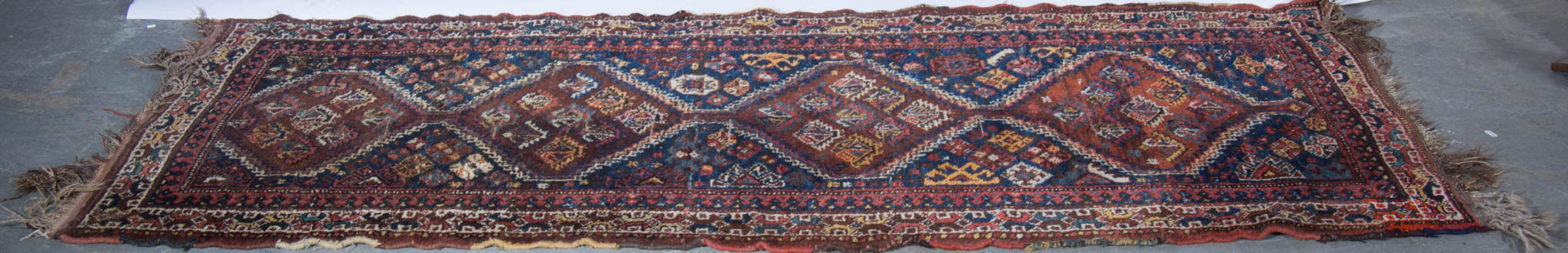 Hamadan bordered runner with four diamond medallions joined on a blue ground,