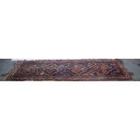 Hamadan bordered runner with four diamond medallions joined on a blue ground,