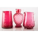 Cranberry glass tapering jug, 21cms and three other Cranberry jugs, (4).