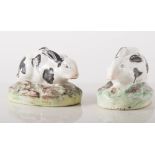 Two Staffordshire models of Rabbits, each sat on oval bases, 5.5cms high, 8cms long.