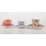 Miniature Coalport cabinet cup and saucer, gilt decoration on a pink ground, height overall 5cm,