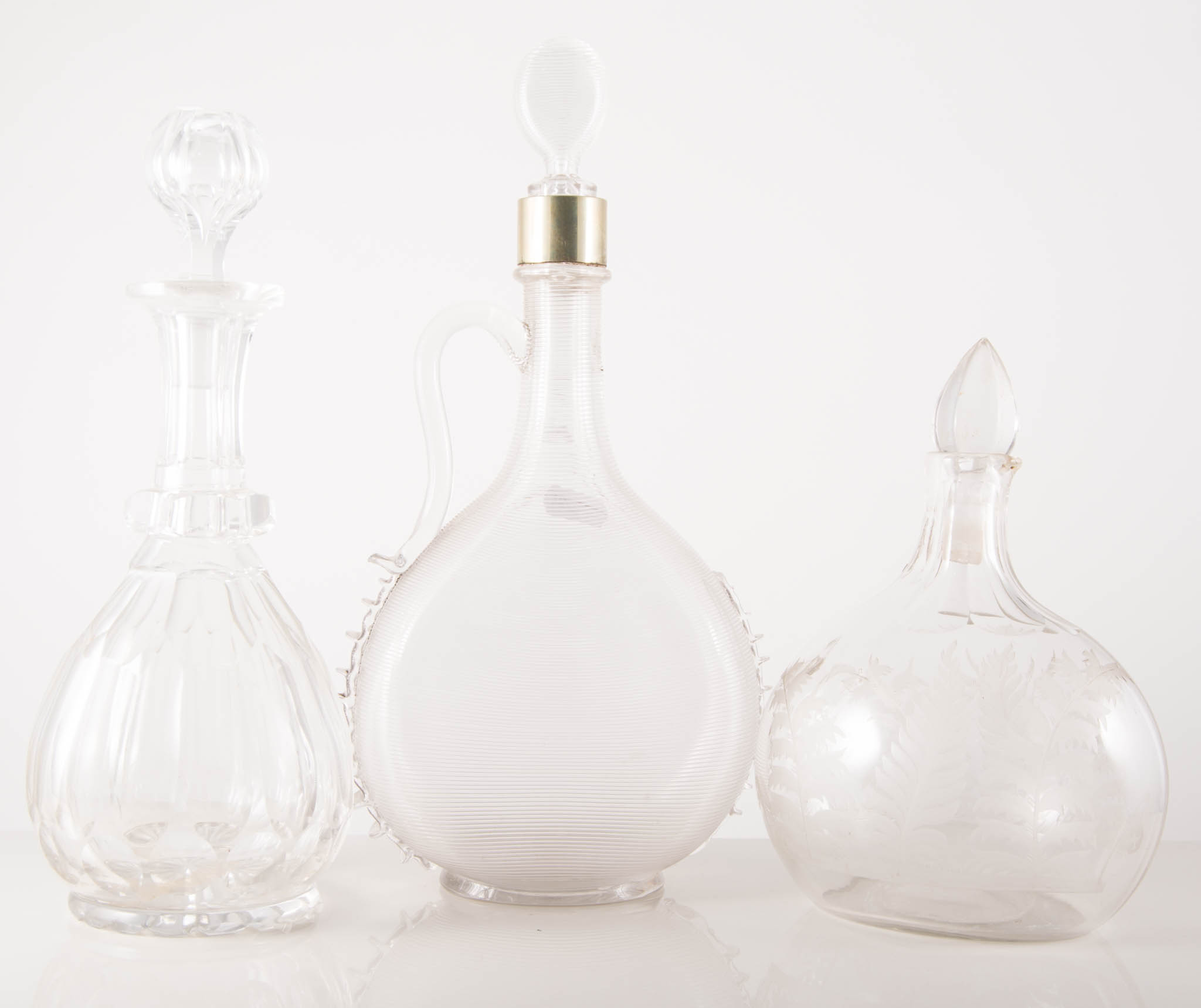 Collection of thirteen glass decanters and stoppers,