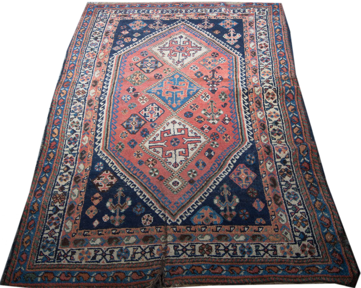 Hamadan multi bordered rug with triple medallion centre on rust ground with hooked outlines,