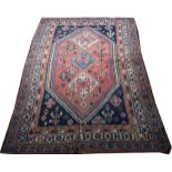 Hamadan multi bordered rug with triple medallion centre on rust ground with hooked outlines,