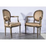 Pair of painted fautueills, oval backs, padded arms, upholstered in champagne upholstery,