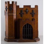 Oak smokers cabinet, the front formed as a castle,