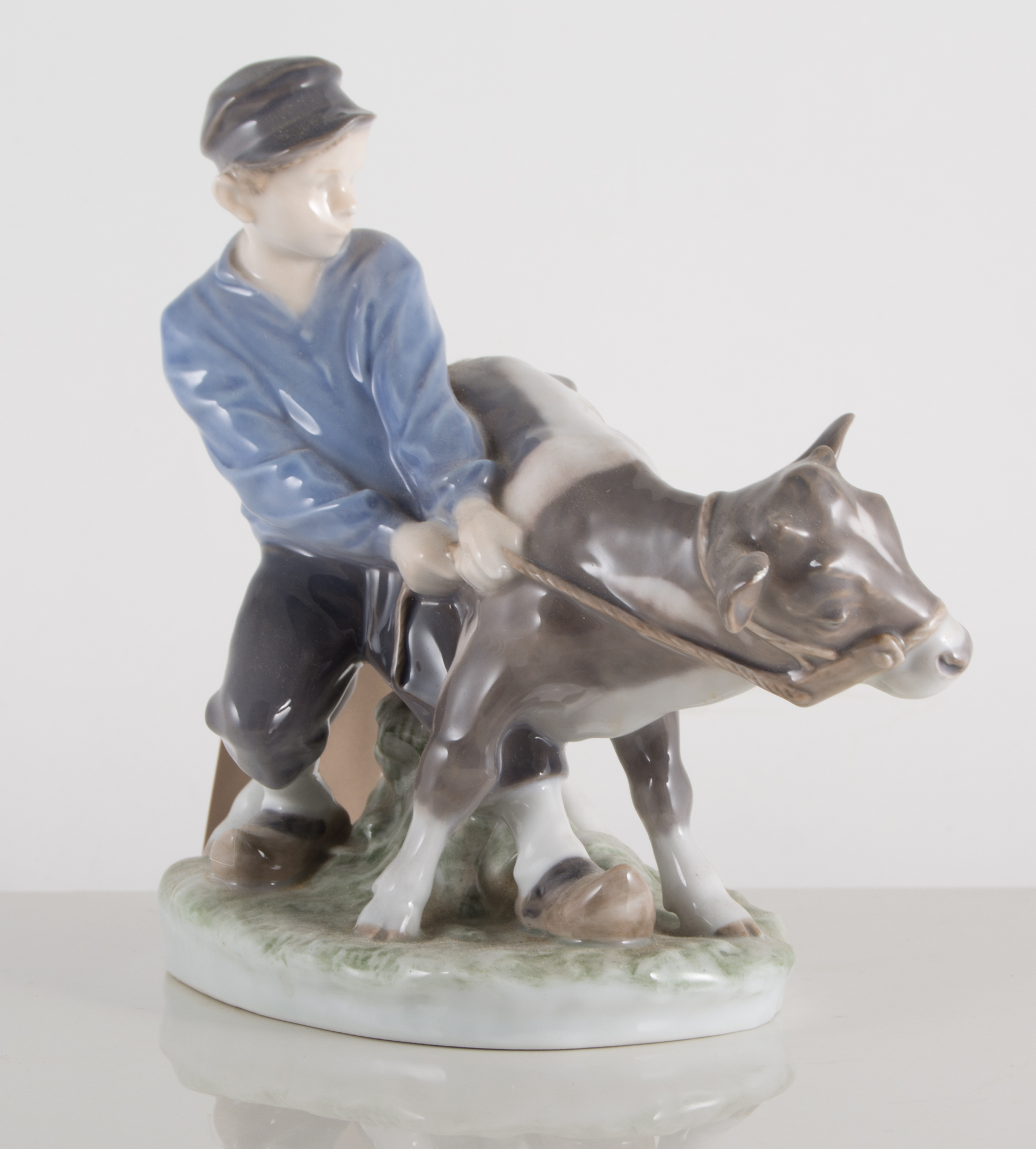 Royal Copenhagen model of a boy with a calf, No. 772, 18cm.