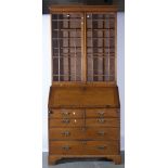 Oak bureau with a matched bookcase top, two multi-pane glazed doors to the upper section,