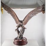 Cast metal model of an Eagle on a branch, stained wood plinth, 72cm.