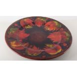 A Moorcroft plate, 'Leaf and Berry' design, flambé glaze, restored, 30cm diameter.