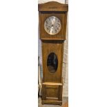 Oak cased grandmother clock, silvered dial, movement striking on seven gongs, 173cm.