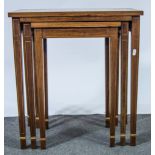 Nest of three rosewood tables, inlaid stringing, tapering supports, width 56cm.