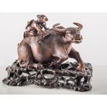 Carved Chinese hardwood buffalo and farmer, on a hardwood stand, 24cm.