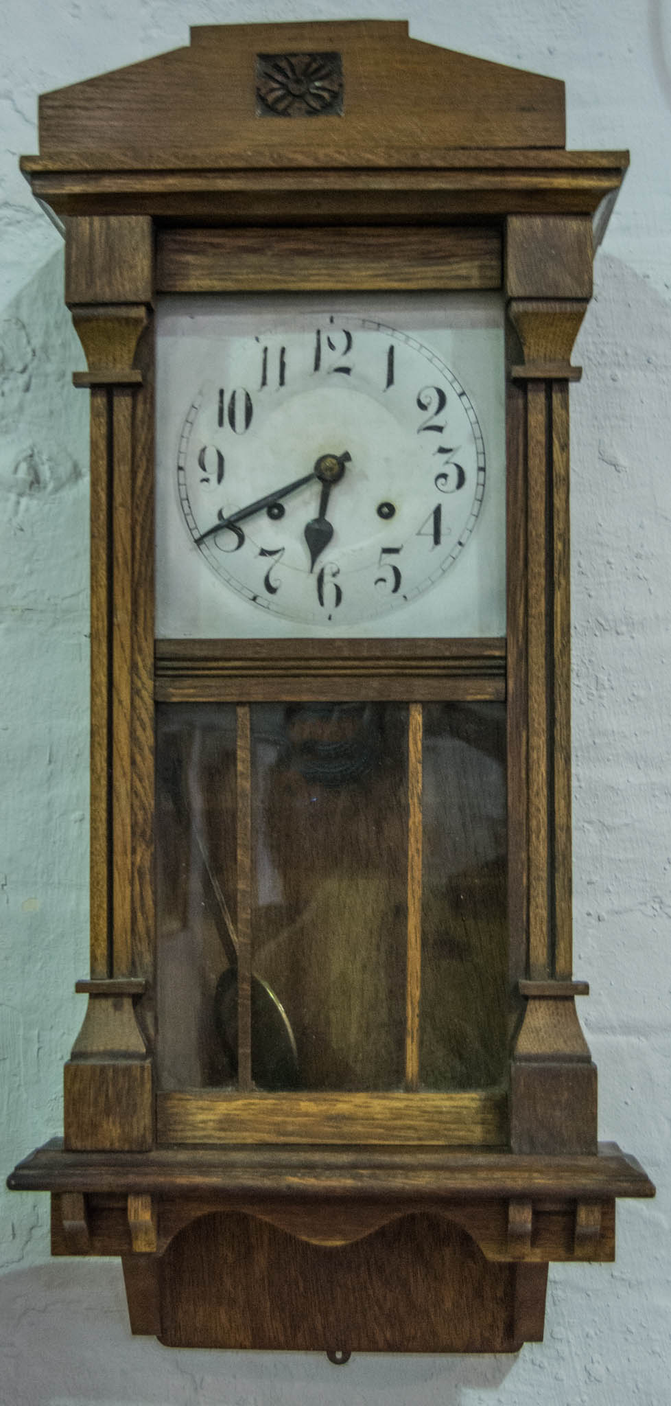 Edwardian oak wall clock, silvered dial, striking on a gong, 78cm.