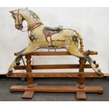Victorian rocking horse, carved and painted wood, on a stained pine trestle base, length 112cms,
