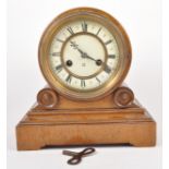 A Victorian golden oak mantle clock, drum case with moulded plinth, ivorine dial,