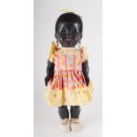 Pedigree walking black doll, with yellow dress and earrings. 42cm tall.