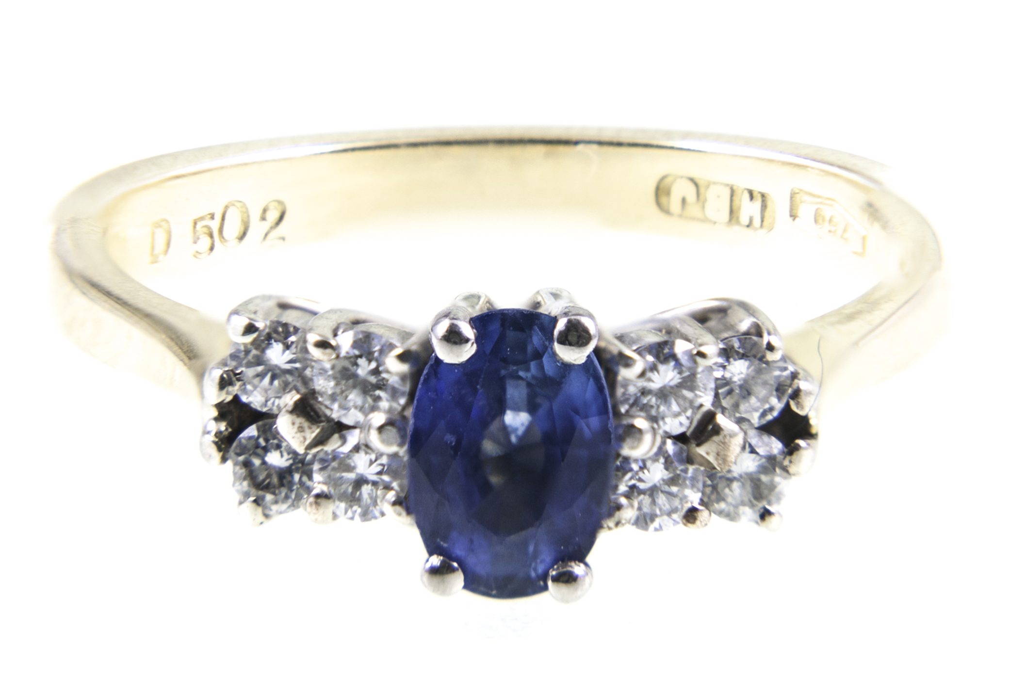 A sapphire and diamond ring, one sapphire, oval mixed cut stone,