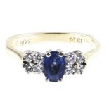 A sapphire and diamond ring, one sapphire, oval mixed cut stone,
