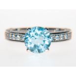 A blue topaz and diamond dress ring,
