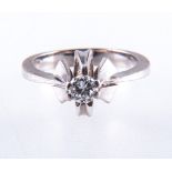 A diamond solitaire ring, the brilliant cut stone set in a white metal raised six claw modern mount,