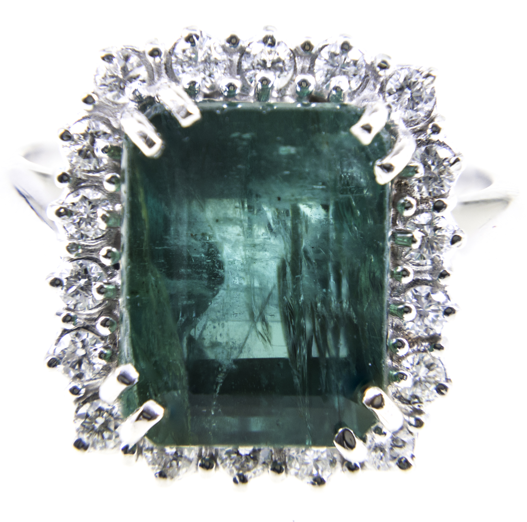 An emerald and diamond rectangular cluster ring, one step cut emerald 12.4mm x 9.5mm x 8.