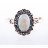 An opal and diamond dress ring, one oval cabochon cut opal, 9.2mm x 6.