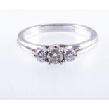 A diamond three stone ring, the brilliant cut stones, graduating in size,
