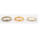 22ct gold band (2.6g), a wedding band, and a 9ct half eternity ring. (3).