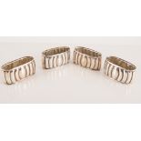 Five silver napkin rings, oval section, fluted, and a Victorian silver mounted glass bottle.