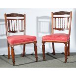 Set of six late Victorian walnut dining chairs, carved arch crestings with flowers and leaves,