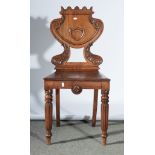 Victorian mahogany hall chair, carved shield back, raised on fluted supports.