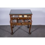 Electroplated canteen of cutlery, in a figured walnut two drawer table cabinet.