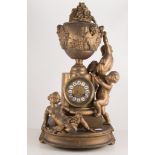 French gilt metal mantel clock, surmounted by three putti and a classical urn, 52cm.