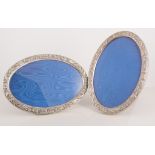 Pair of modern oval silver photograph frames,