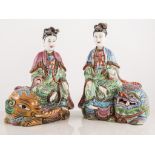 Pair of Japanese polychrome figures, modelled beside a temple lion and elephant, 27cm,