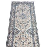 Wool machine-made runner, ivory ground, with three blue medallions all over foliate design,