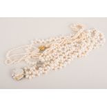 A triple entwined freshwater pearl necklace, silver gilt clasp,