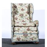 Traditional wing-backed easy chair, floral pattern, width 68cm.