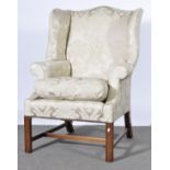 A Georgian style wing-back armchair.