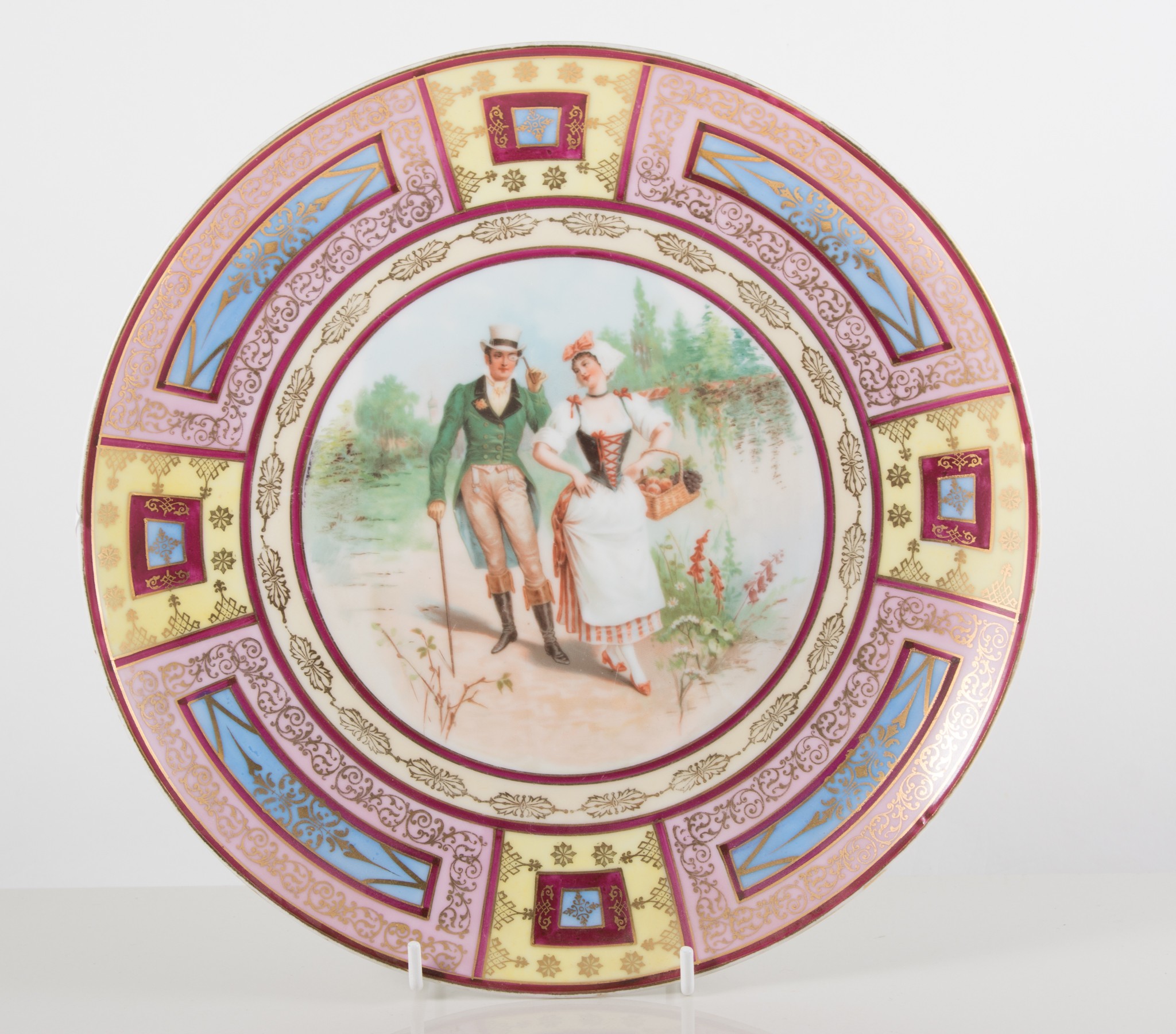 Pair of Viennese porcelain chargers, circular dished form, each decorated with a courting couple,