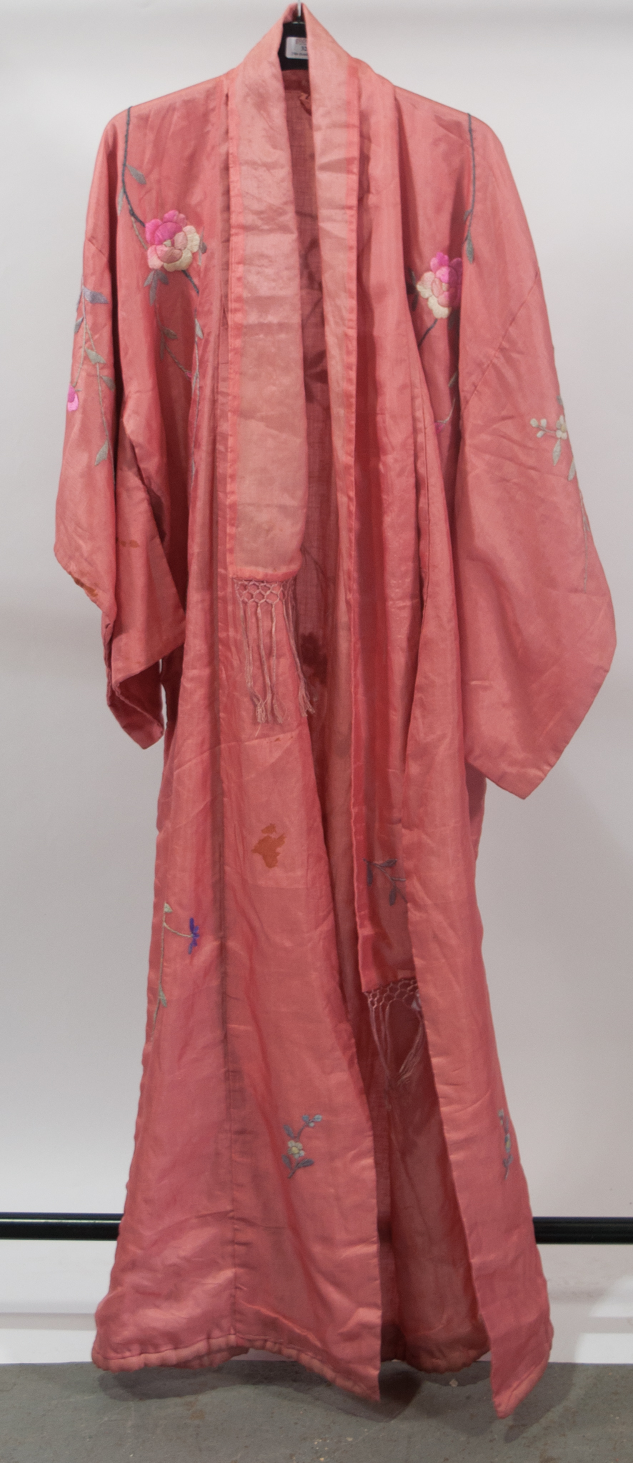 Salmon pink silk kimono, 1930s, with floral embroidered decoration, complete with sash.