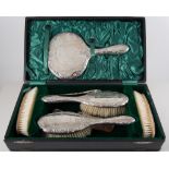 Silver backed dressing table set, two hair brushes, two clothes brushes, a hand mirror, comb,