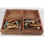 Large collection of lace bobbins, mostly wooden and beaded, in two Indian inlaid teak wood boxes.