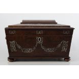 A rosewood domed top sewing box 26cm x 20cm x 17cm, inlaid with mother-of-pearl floral motifs,