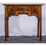 A George II style walnut lowboy, 18th century and later,