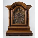 Walnut bracket clock, arched dial with cast spandrels, Roman numerals,