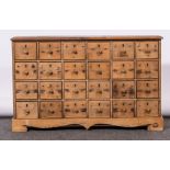 Set of pine spice drawers, comprising four banks of six drawers, raised on a shaped apron,