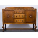 A 1940s solid oak dining suite, comprising extending table, four chairs and sideboard.