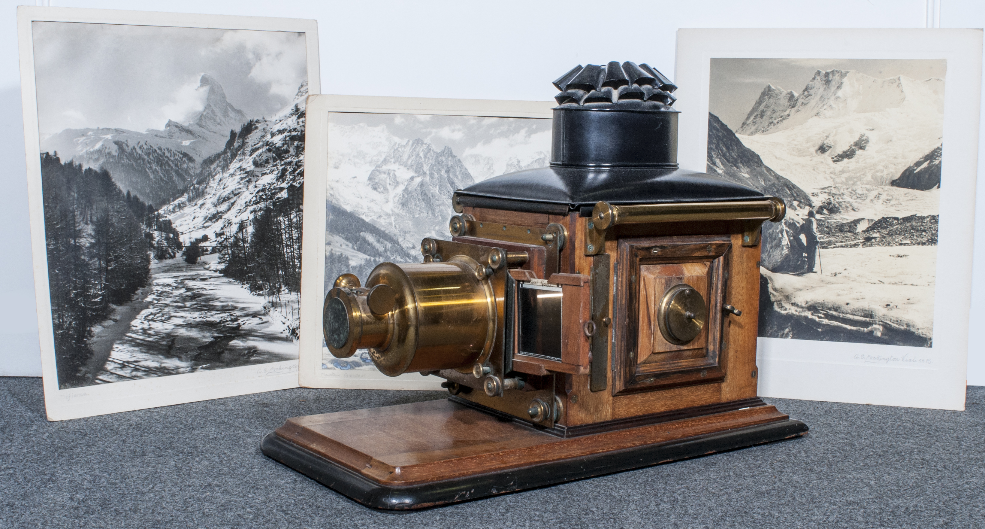 A Victorian mahogany, lacquered brass and tin lantern projector, (converted to electricity),